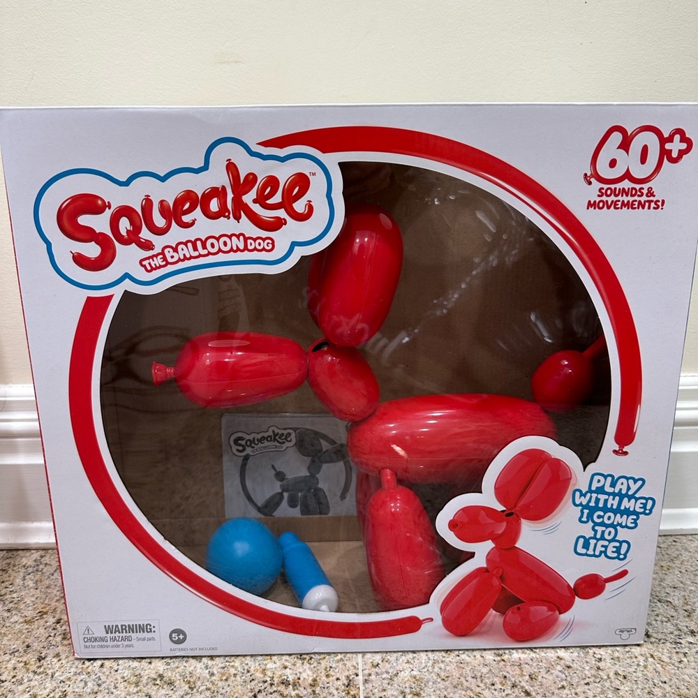 Squeakee the balloon dog. Includes pictured accessories, box, and instructions.